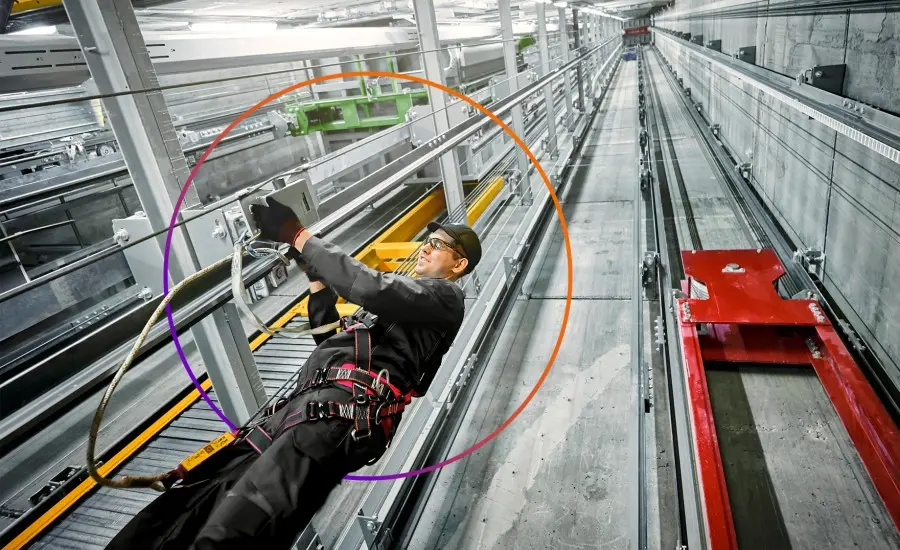 TK Elevator technician servicing elevator control equipment